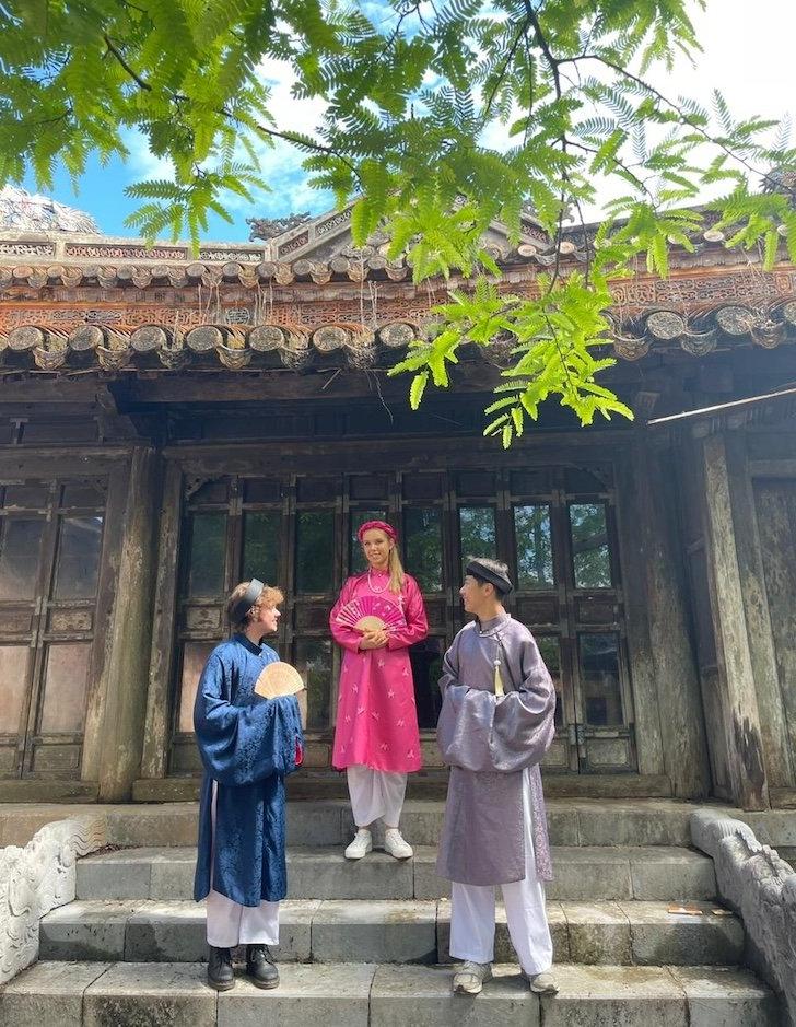 3 students in front of temple in Vietnam